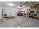 A spacious garage featuring storage shelving and a workbench at 6661 Gallup Ct, Pahrump, NV 89060