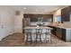 Modern kitchen boasts stainless steel appliances, a granite-topped island with seating, and dark wood cabinetry at 6661 Gallup Ct, Pahrump, NV 89060