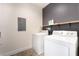 Laundry room with washer, dryer, and a dark accent wall at 6661 Gallup Ct, Pahrump, NV 89060