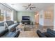Stylish living room with comfortable seating, a ceiling fan, and entertainment center; windows offering bright natural light at 6661 Gallup Ct, Pahrump, NV 89060