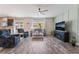 Inviting living room features cozy seating, a ceiling fan, and a modern entertainment center with a fireplace at 6661 Gallup Ct, Pahrump, NV 89060