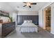 Comfortable main bedroom with patterned accent wall, white bed frame and ensuite bath at 6661 Gallup Ct, Pahrump, NV 89060