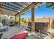 Outdoor patio with a hot tub, fire pit, comfortable seating, and a covered pergola at 7154 Brighton Village St, Las Vegas, NV 89166