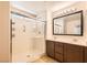 Modern bathroom featuring a glass shower and double sink vanity with warm accents at 7154 Brighton Village St, Las Vegas, NV 89166