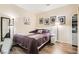 Inviting bedroom featuring a plush queen bed, stylish decor, and wood-look flooring at 7154 Brighton Village St, Las Vegas, NV 89166