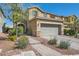 Inviting two-story home featuring a well-manicured lawn, stone accents, and a spacious two-car garage at 7154 Brighton Village St, Las Vegas, NV 89166