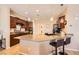 Well-lit kitchen with dark wood cabinets, granite countertops, and an island with barstool seating at 7154 Brighton Village St, Las Vegas, NV 89166
