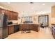 Spacious kitchen featuring dark wood cabinets, granite countertops, and an open layout at 7154 Brighton Village St, Las Vegas, NV 89166