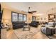Spacious living room featuring a ceiling fan, tile flooring, and neutral tones at 7154 Brighton Village St, Las Vegas, NV 89166