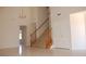 Home entryway featuring tile floors, staircase with wood trim and a chandelier at 7720 Leavorite Dr, Las Vegas, NV 89128