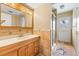 Bathroom featuring a vanity with a mirror, tiled walls, and a glass enclosed shower at 816 Antigua St, Las Vegas, NV 89145