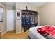 This bedroom has an open closet full of clothes, hats, and personal certificates at 816 Antigua St, Las Vegas, NV 89145