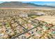Drone shot of a residential area surrounded by desert, displaying community layout at 8220 Tursi Lodge Ct, Las Vegas, NV 89131
