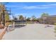 Backyard with trampoline, jungle gym, and basketball hoop on a concrete surface at 8220 Tursi Lodge Ct, Las Vegas, NV 89131