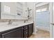 Bathroom with double sinks, granite countertops, and shower/tub combo behind glass door at 8220 Tursi Lodge Ct, Las Vegas, NV 89131