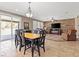 Open-concept dining area with tile flooring, modern light fixture, and seamless access to the outdoor patio at 8220 Tursi Lodge Ct, Las Vegas, NV 89131