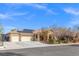 Lovely home with a three-car garage, tile roof, well-kept lawn and desert landscaping on a sunny day at 8220 Tursi Lodge Ct, Las Vegas, NV 89131