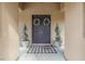 Elegant double front doors adorned with wreaths, complemented by potted plants and a stylish welcome mat at 8220 Tursi Lodge Ct, Las Vegas, NV 89131