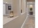 Hallway showing tiled floors, archways and niches for artwork and plants at 8220 Tursi Lodge Ct, Las Vegas, NV 89131