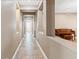 Hallway with tiled floors, decorative columns, and a glimpse of a grand piano in the background at 8220 Tursi Lodge Ct, Las Vegas, NV 89131