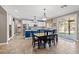 Bright kitchen featuring an island with seating, stainless steel appliances, and sliding glass doors to the backyard at 8220 Tursi Lodge Ct, Las Vegas, NV 89131