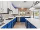 Bright kitchen with stainless steel appliances, white cabinets, and blue lower cabinets with a large island at 8220 Tursi Lodge Ct, Las Vegas, NV 89131