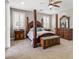 The main bedroom is furnished with a four-poster bed and elegant wooden furniture at 8220 Tursi Lodge Ct, Las Vegas, NV 89131