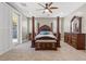 The main bedroom is furnished with a four-poster bed and elegant wooden furniture at 8220 Tursi Lodge Ct, Las Vegas, NV 89131