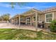 Open backyard patio with full cover, fan and lights, ideal for outdoor dining and entertaining at 8220 Tursi Lodge Ct, Las Vegas, NV 89131