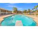 Backyard pool features diving board, lush landscaping, and secure fencing perfect for leisure and safety at 8220 Tursi Lodge Ct, Las Vegas, NV 89131