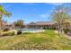 Backyard pool with grassy lawn and nearby covered patio at 8220 Tursi Lodge Ct, Las Vegas, NV 89131