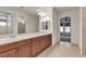 Bathroom featuring double sinks, wooden cabinetry, and tile flooring at 8393 Canyon Crevasse St, Las Vegas, NV 89166
