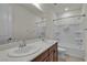 Bathroom featuring double sinks, a large mirror, and a shower-tub combination, blending style and functionality at 8393 Canyon Crevasse St, Las Vegas, NV 89166