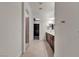 Hallway leading to the bathroom with double vanity and walk-in shower at 8393 Canyon Crevasse St, Las Vegas, NV 89166