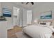 Staged bedroom with white bedding and art; closet and bathroom access at 8393 Canyon Crevasse St, Las Vegas, NV 89166