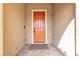 Close-up of the orange front door with a welcoming entryway and neutral stucco walls at 8393 Canyon Crevasse St, Las Vegas, NV 89166