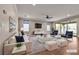 Spacious living room with a plush sofa, accent chairs, and natural light creating an inviting atmosphere at 8393 Canyon Crevasse St, Las Vegas, NV 89166