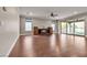 Spacious living room with hardwood floors, a ceiling fan, and sliding doors to the backyard at 8393 Canyon Crevasse St, Las Vegas, NV 89166