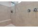 Modern shower with adjustable spray head and tiled walls, plus seating at 8393 Canyon Crevasse St, Las Vegas, NV 89166