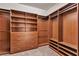 Spacious walk-in closet featuring custom wood shelving, drawers, and ample hanging space, providing optimal organization at 8393 Canyon Crevasse St, Las Vegas, NV 89166