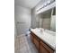 Well-maintained bathroom with a vanity, tile countertop and modern fixtures at 8501 W University Ave # 1128, Las Vegas, NV 89147