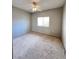 Clean bedroom with carpet, overhead fan and natural light from window at 8501 W University Ave # 1128, Las Vegas, NV 89147