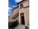 Condo exterior featuring a two-story facade, walkway, and private entry at 8501 W University Ave # 1128, Las Vegas, NV 89147