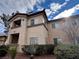 Condo exterior features a two-story facade, landscaping, and private covered balcony at 8501 W University Ave # 1128, Las Vegas, NV 89147