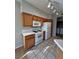 Bright kitchen with white appliances, tile countertops, and wood cabinets at 8501 W University Ave # 1128, Las Vegas, NV 89147