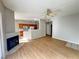 Open-concept living room features hardwood flooring, ceiling fan, fireplace, and access to the kitchen at 8501 W University Ave # 1128, Las Vegas, NV 89147
