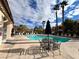 Community pool with seating areas, lounge chairs, and meticulously manicured landscaping at 8501 W University Ave # 1128, Las Vegas, NV 89147
