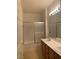 Bathroom featuring double sinks with vanity and shower with sliding glass doors at 8555 W Russell Rd # 1078, Las Vegas, NV 89113