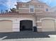 Exterior view of the home featuring three garage doors at 8555 W Russell Rd # 1078, Las Vegas, NV 89113