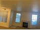 Bright living room featuring a decorative fireplace, two large windows, and ample natural light at 8555 W Russell Rd # 1078, Las Vegas, NV 89113